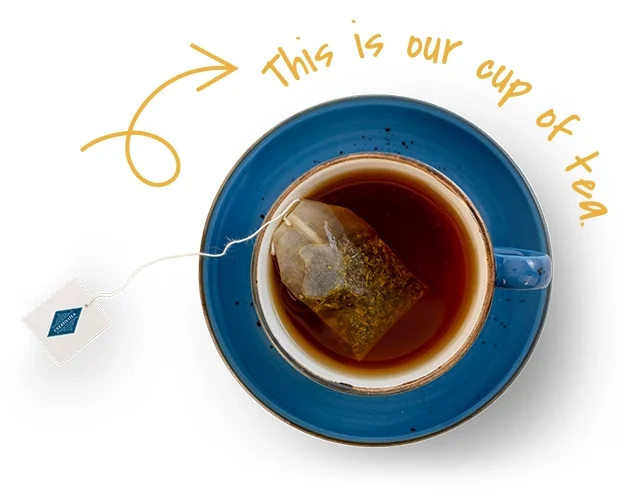 A top view of a blue cup of tea with a teabag, labeled "This is our cup of tea," against a plain background.